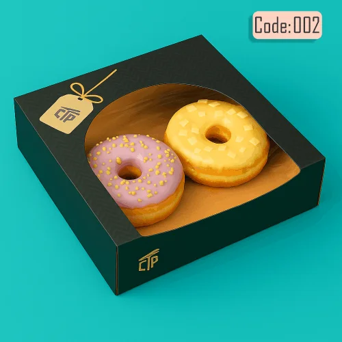 Two colorful donuts, one purple with sprinkles and one yellow, in a square black box with a decorative gift tag.