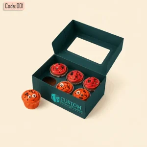 Turquoise cardboard muffin boxes with window lid holding six decorated red cupcakes, with one cupcake placed outside the box.