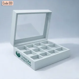 White luxury chocolate gift sweet boxes with a transparent hinged lid and multiple internal compartments, branded with Custom Packaging Wholesale logo.